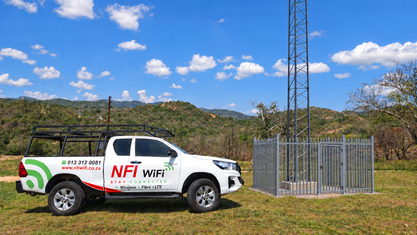 NFI WiFi service bakkie beside a fixed-wireless tower and palisade enclosure